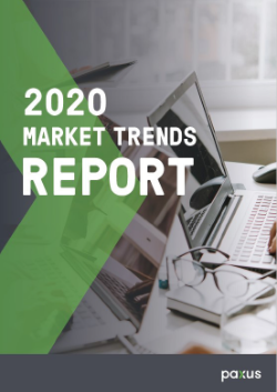 Cover page of the 2020 market trends report detailing the year's business insights and analyses, featuring an office workspace with a laptop and eyeglasses.