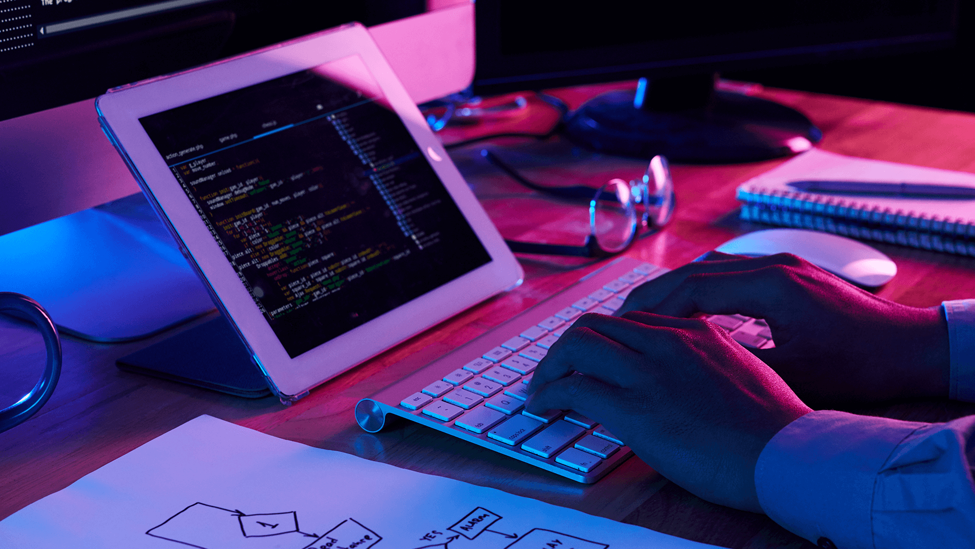 A developer working late at night, typing on a keyboard with a focus on coding and system architecture, illuminated by the glow of multiple screens.