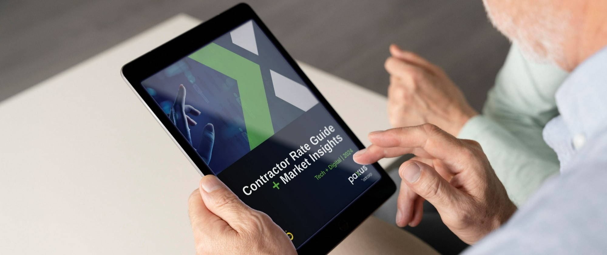 A person holding a tablet displaying a presentation slide with the title "contractor rate guide + marketing insights."