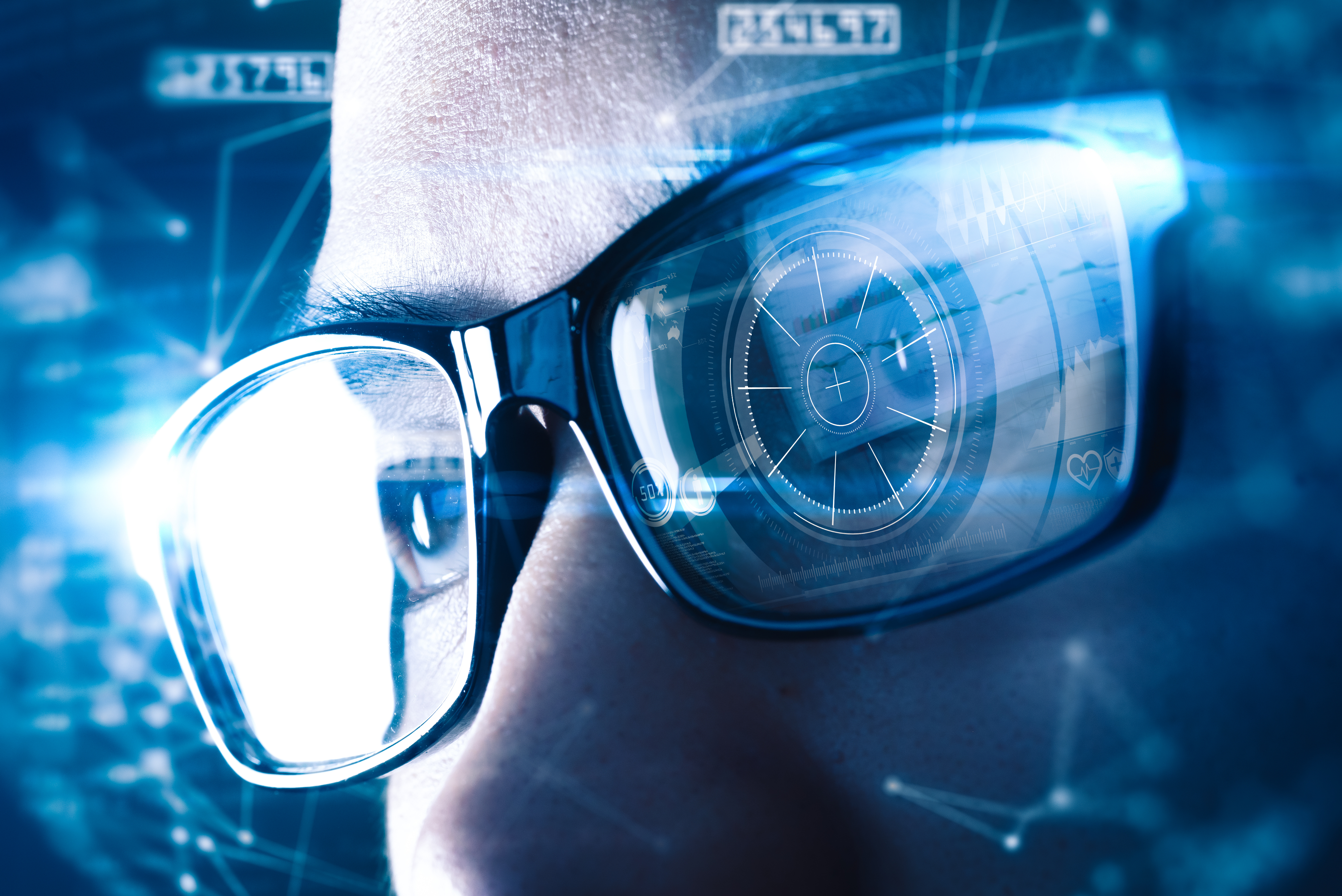 A close-up of an individual wearing modern glasses with futuristic digital overlays, suggesting concepts of augmented reality, advanced technology, and data integration.