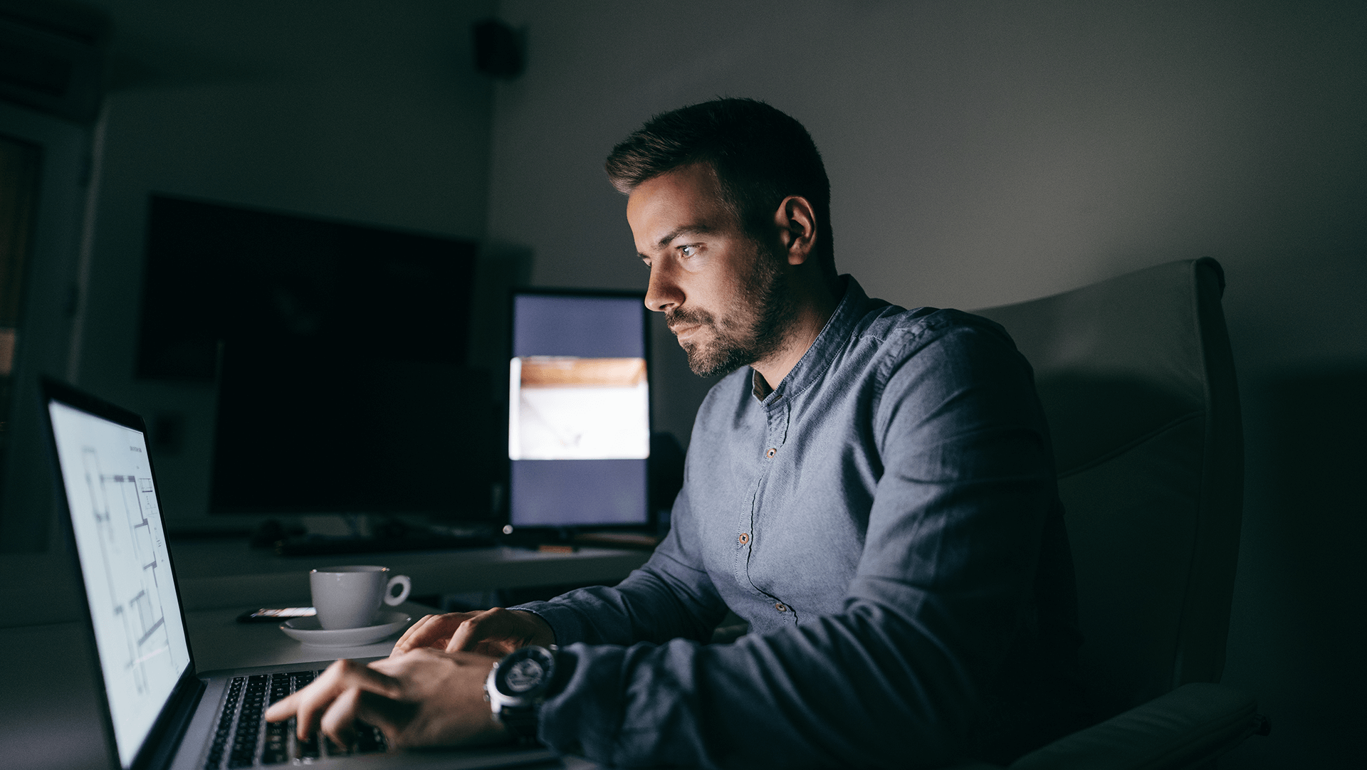 man working remotely at night